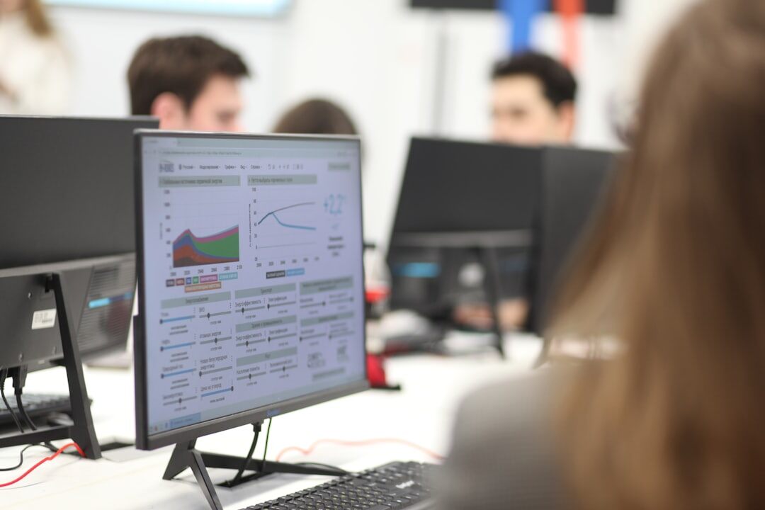 Small newsroom team reviewing a rundown on a monitor